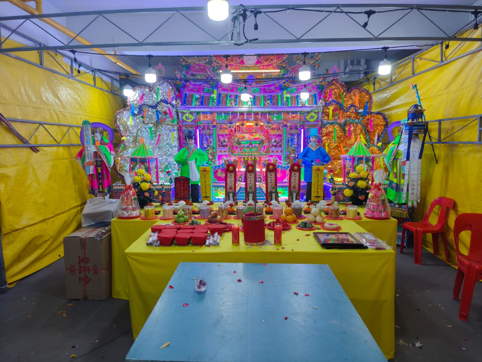 Traditional outdoor funeral setup with elaborate altar