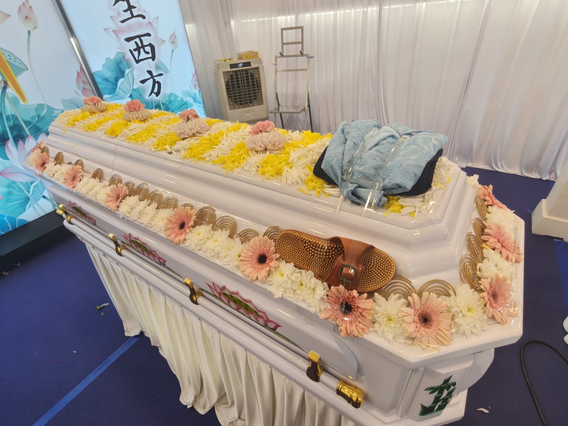 Elegant white casket with floral arrangements